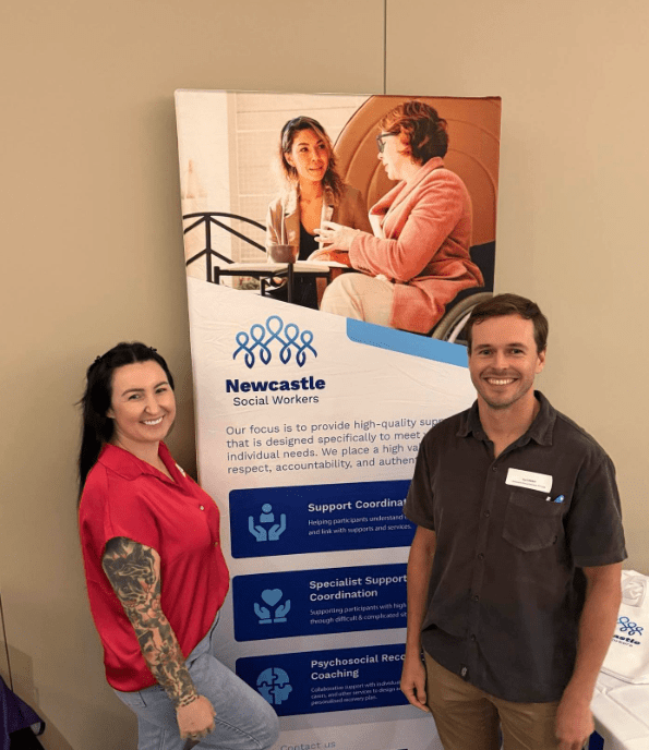 Kurt and Ashley from Newcastle Social Workers at a local disability expo, connecting with the community and sharing information about NDIS support coordination.