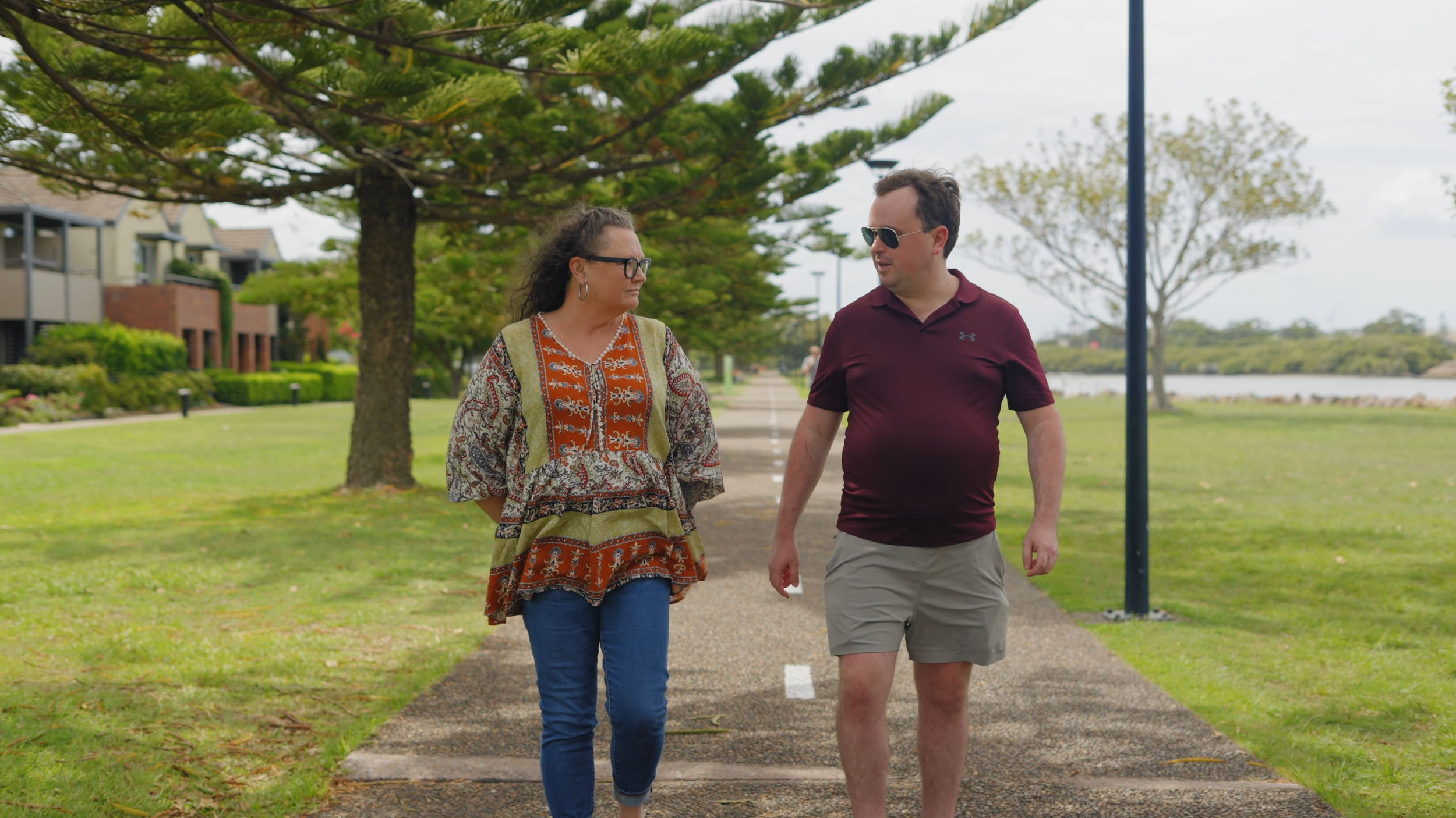 Michelle from Newcastle Social Workers walking with an NDIS participant in the Newcastle community, reflecting local, person-centred support coordination.