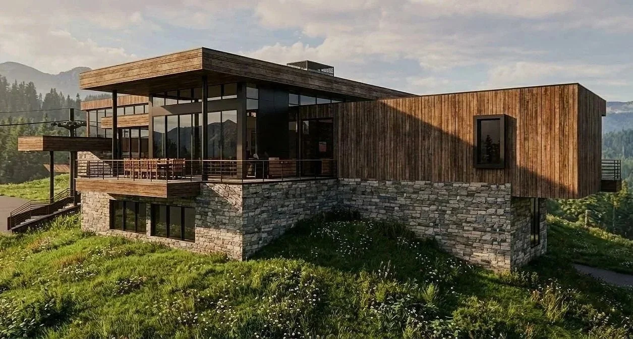 Modern house with stone foundation, wooden siding, large glass windows, and a spacious balcony on a grassy hillside, overlooking distant mountains.