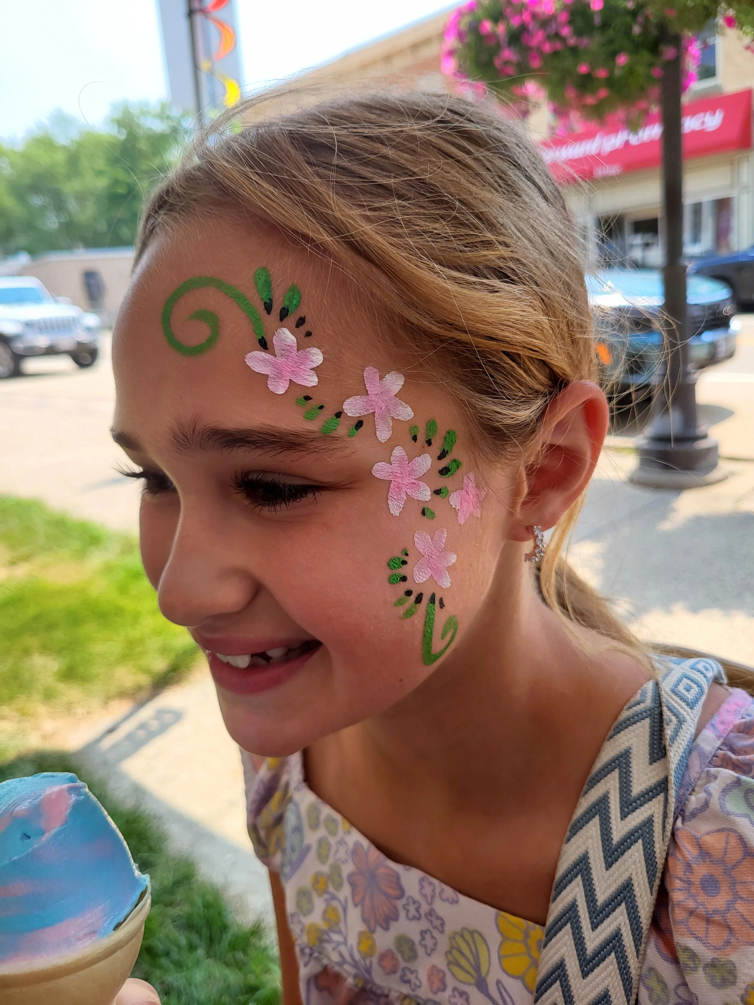 birthday girl smiling at her flower face painting madison wisconsin