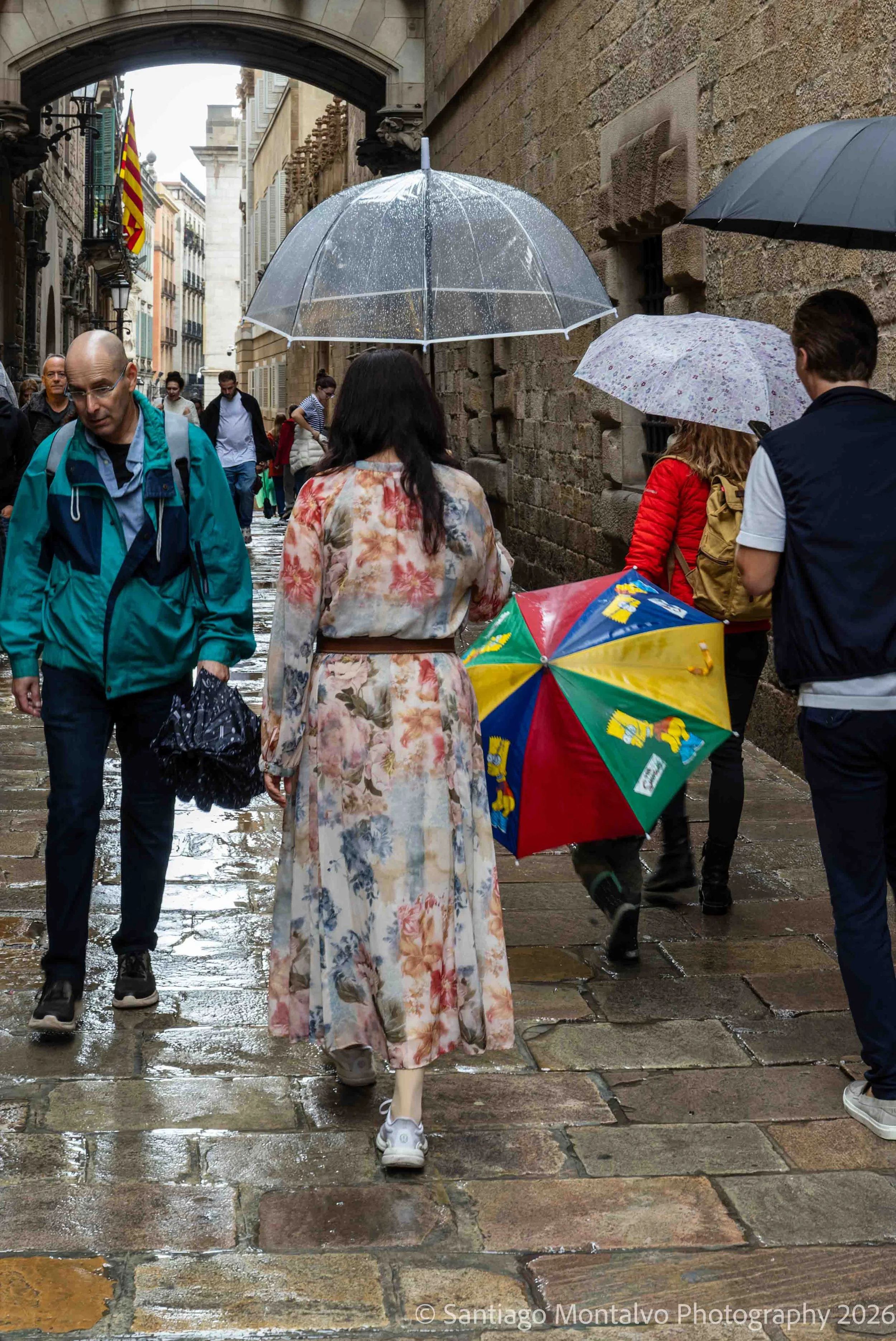 A Rainy Day in the Gothic Quarter — Barcelona, Spain. Colorful umbrellas and shimmering streets reveal a lively moment in the old city.