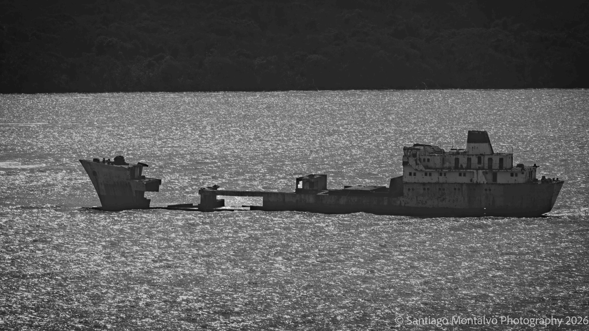 The Forgotten Vessel — Panama Canal, Panama. Weathered metal and shimmering water become an unexpected monochrome composition.