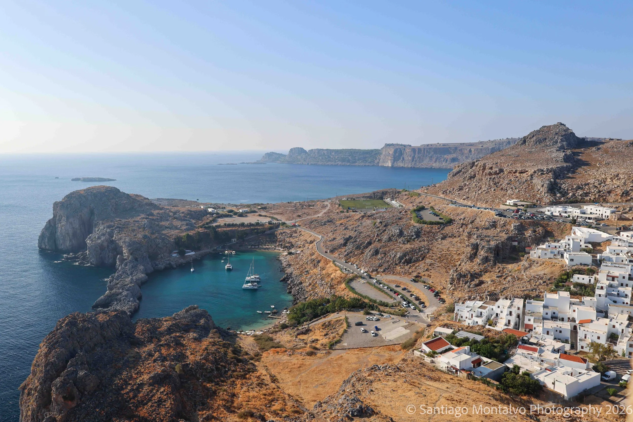 The Mediterranean Cove — Rhodes, Greece. Turquoise waters embrace the rugged curves of the island's coastline.