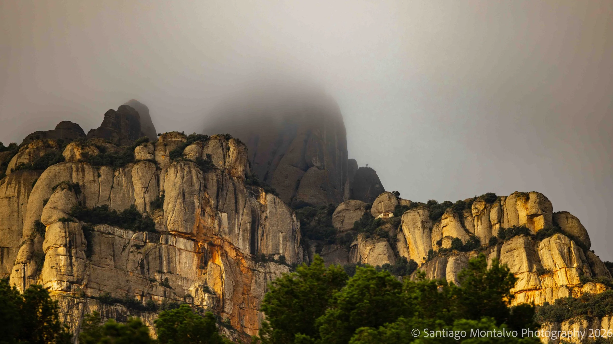 Mountains in the Mist — Montserrat, Spain. Ancient rocky peaks emerge through drifting clouds and soft sunlight.