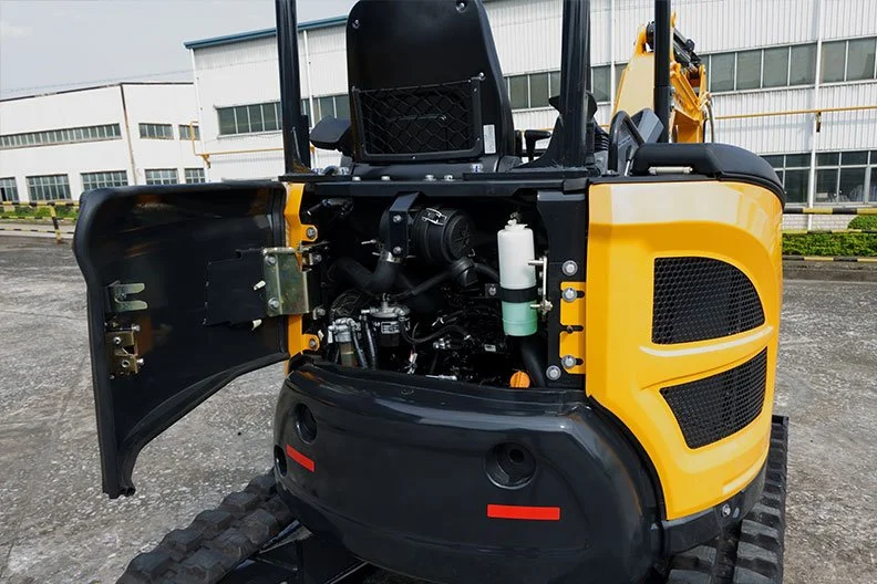 Close-up of the engine compartment of a yellow compact excavator with an open cover, showing internal mechanical parts, engine components, and a white fluid container.