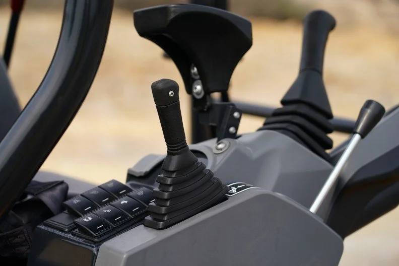 Close-up of the control levers and switches inside a construction vehicle or heavy machinery