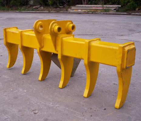 Yellow metal barricade with four legs, shaped like animal legs, placed on asphalt ground.