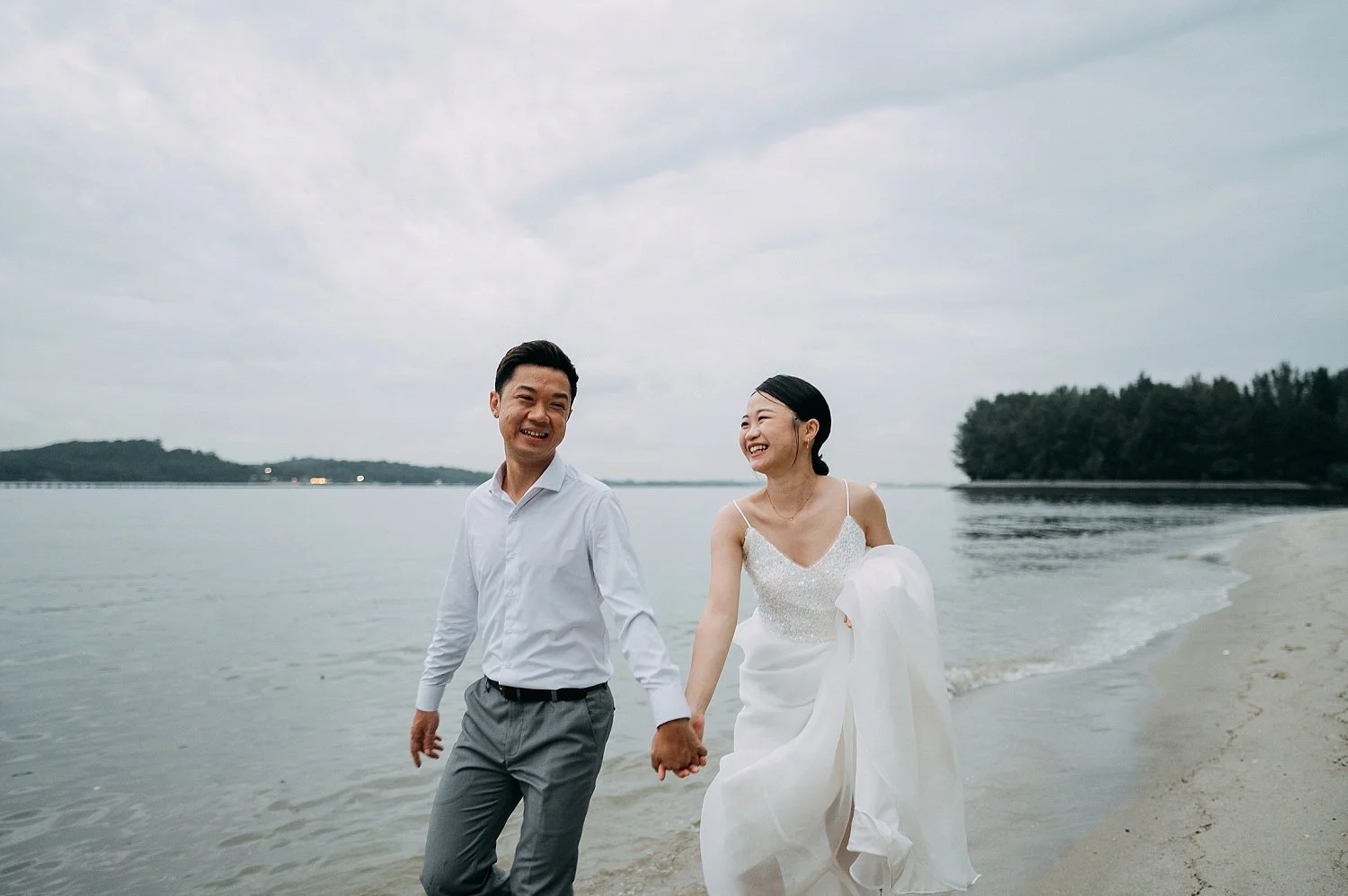  Heartfelt and unscripted portraits of a bride and groom walking by the sea at Coney Island. 