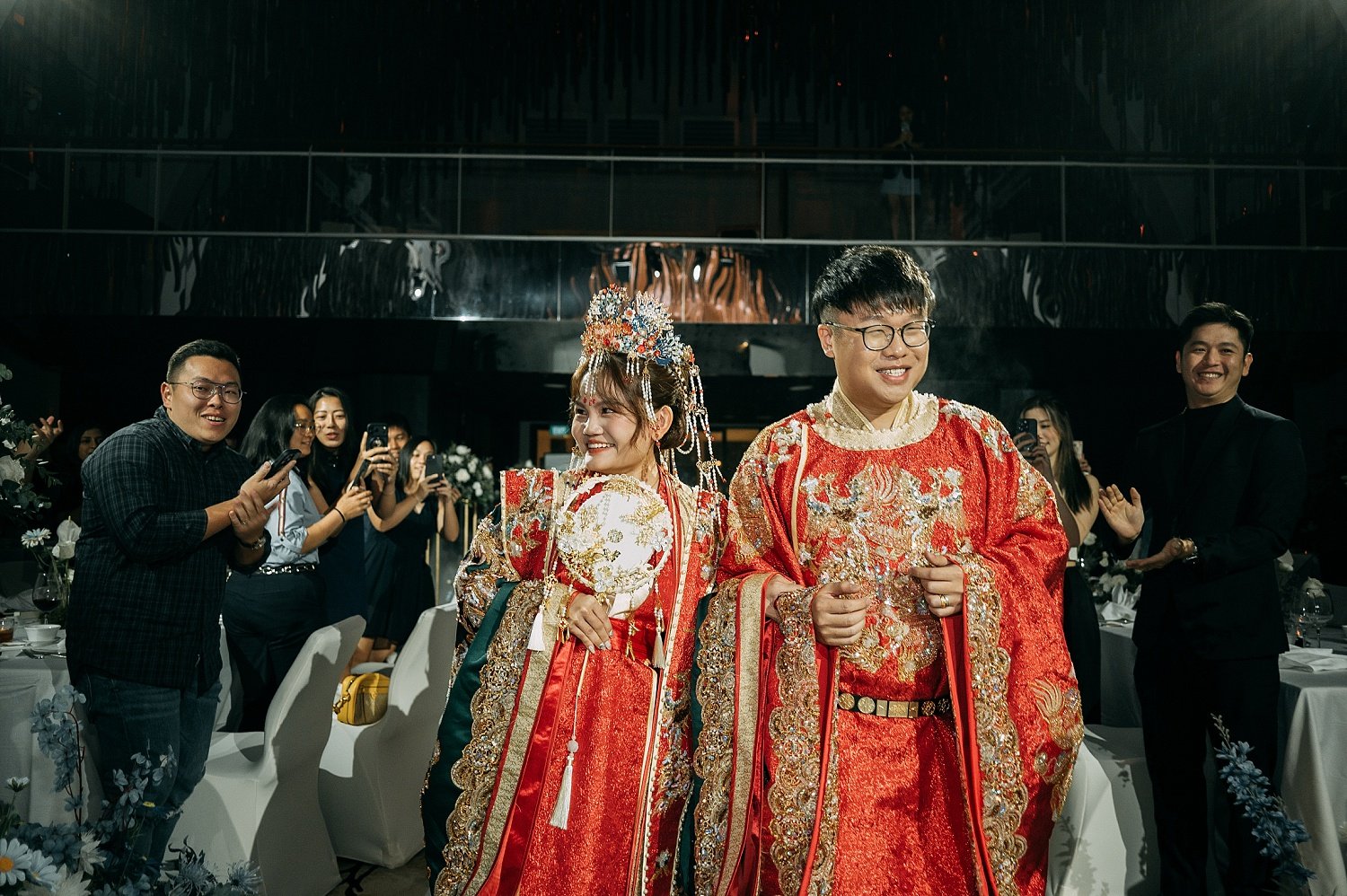  Bride and groom  with a traditional Chinese Dynasty wedding outfits during a grand march in at a Singapore ballroom. 