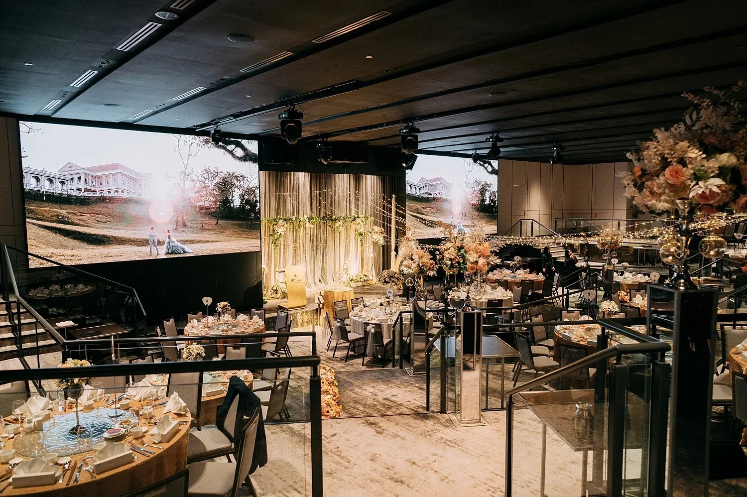 Grand wedding reception at Hilton Orchard Imperial Ballroom with dramatic LED screens.