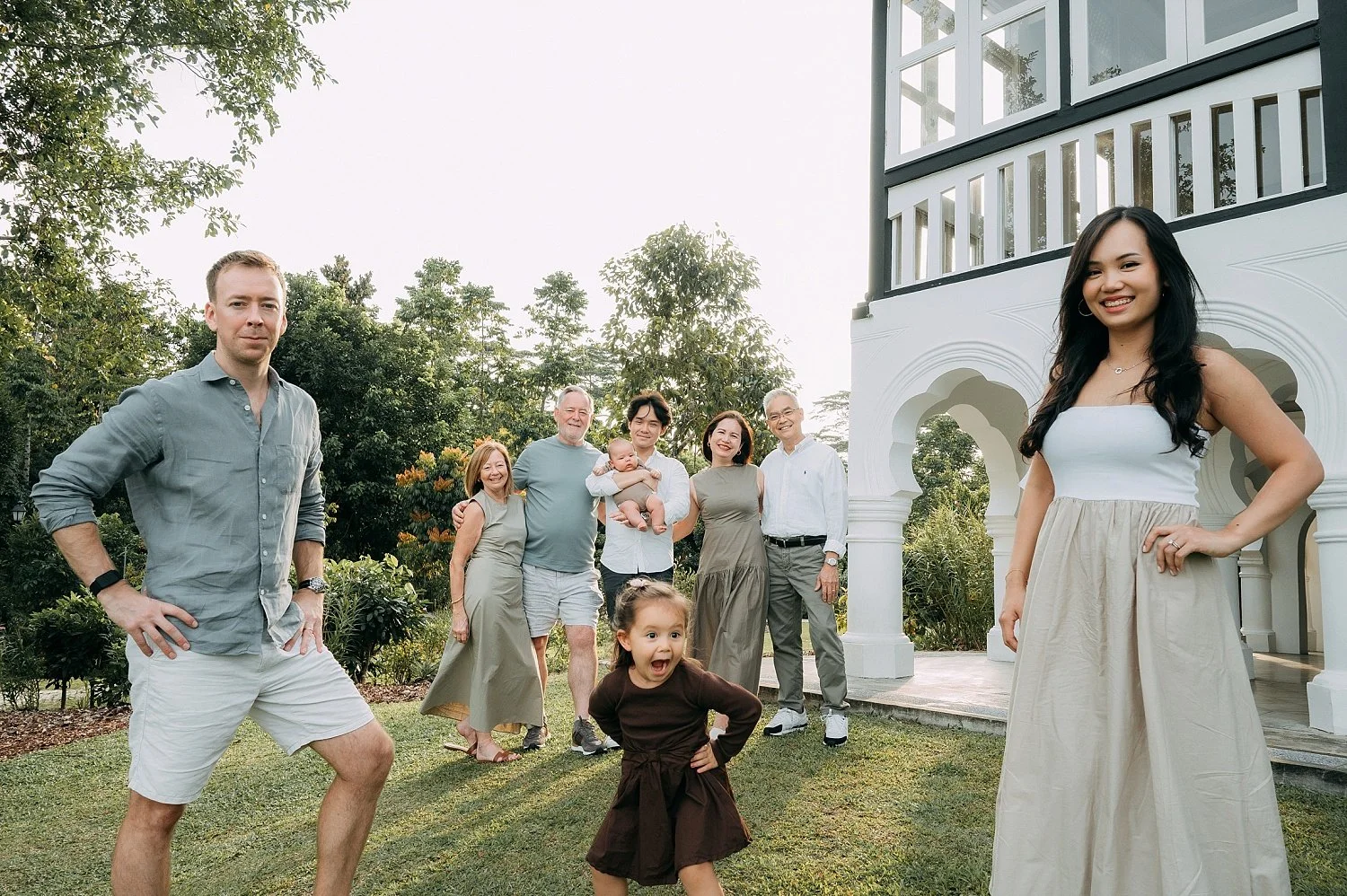 A family group shot. A girl standing in a middle gave a cheeky smile