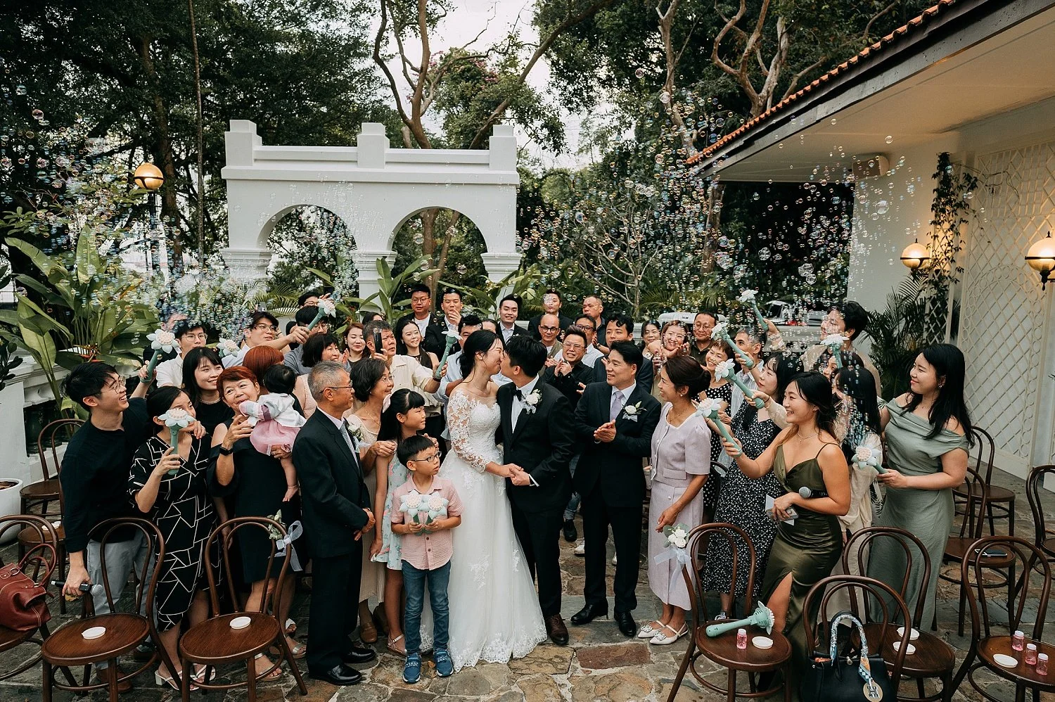 A romantic wedding ceremony at 1-Flowerhill Sentosa with bubbles in the air.