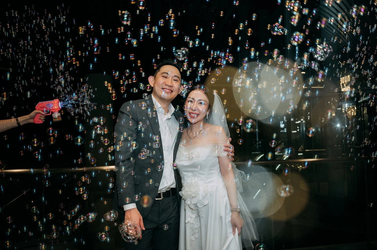 wedding couple photo with full of bubbles making this shots very romantics