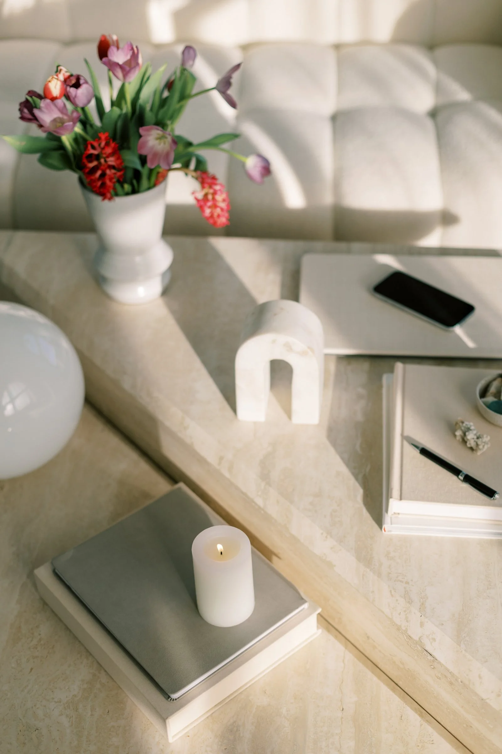 table with candles, journals and flowers
