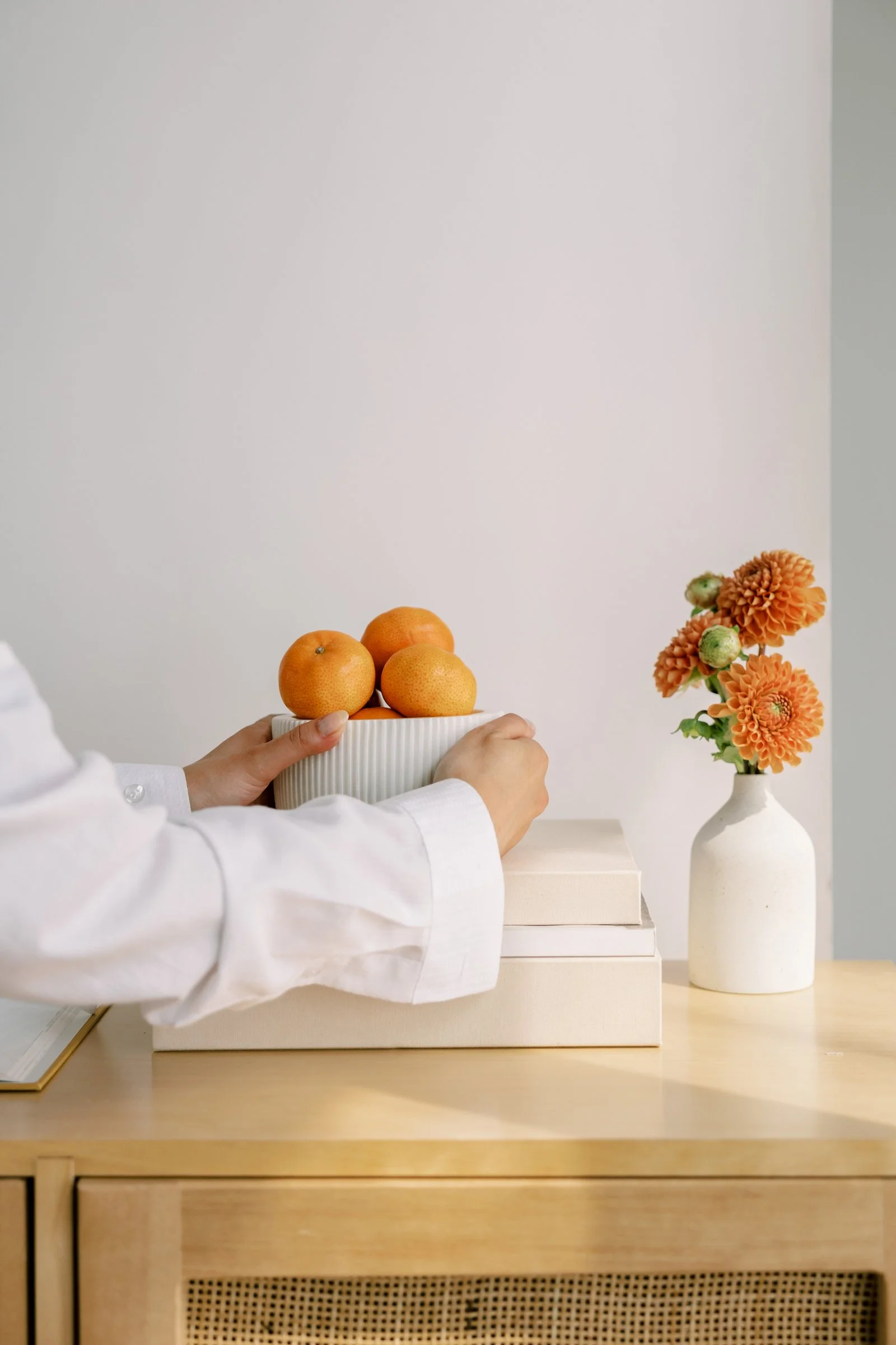 woman adjusting oranges