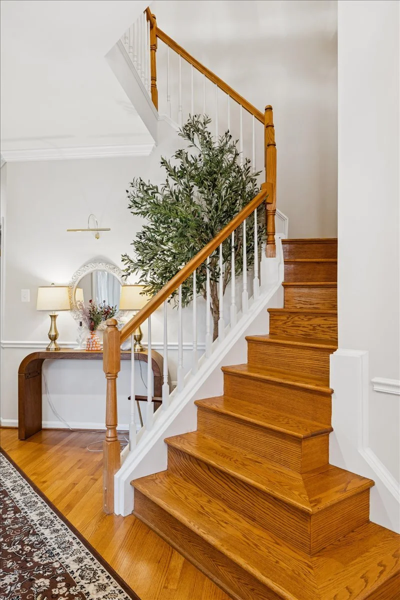 Elegant foyer staircase in a Northern Virginia home evaluated by LeAnne + Co. for accurate property valuation insights