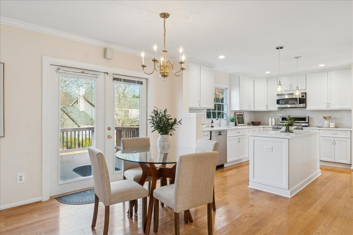 Sophisticated dining room in a luxury Northern Virginia home with round glass table and modern finishes