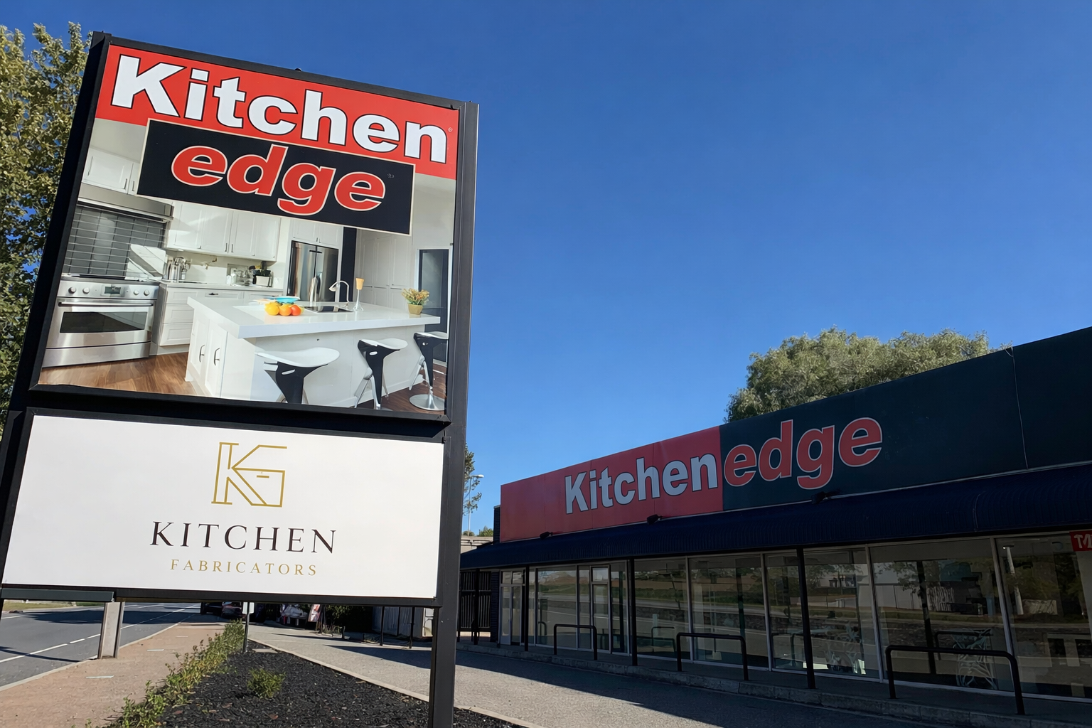 Sign and building for Kitchen Edge, a kitchen appliance store, with signs displaying interior kitchen images and store name in red and white lettering.