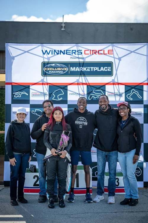 Ana Palestro with family and supporters in the Laguna Seca winner's circle, June 2026