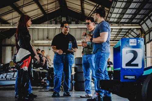 Ana Palestro talking with supporters in the garage beside her #2 F4 car