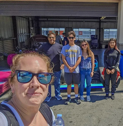 A supporter taking a selfie with Ana Palestro and friends in the garage