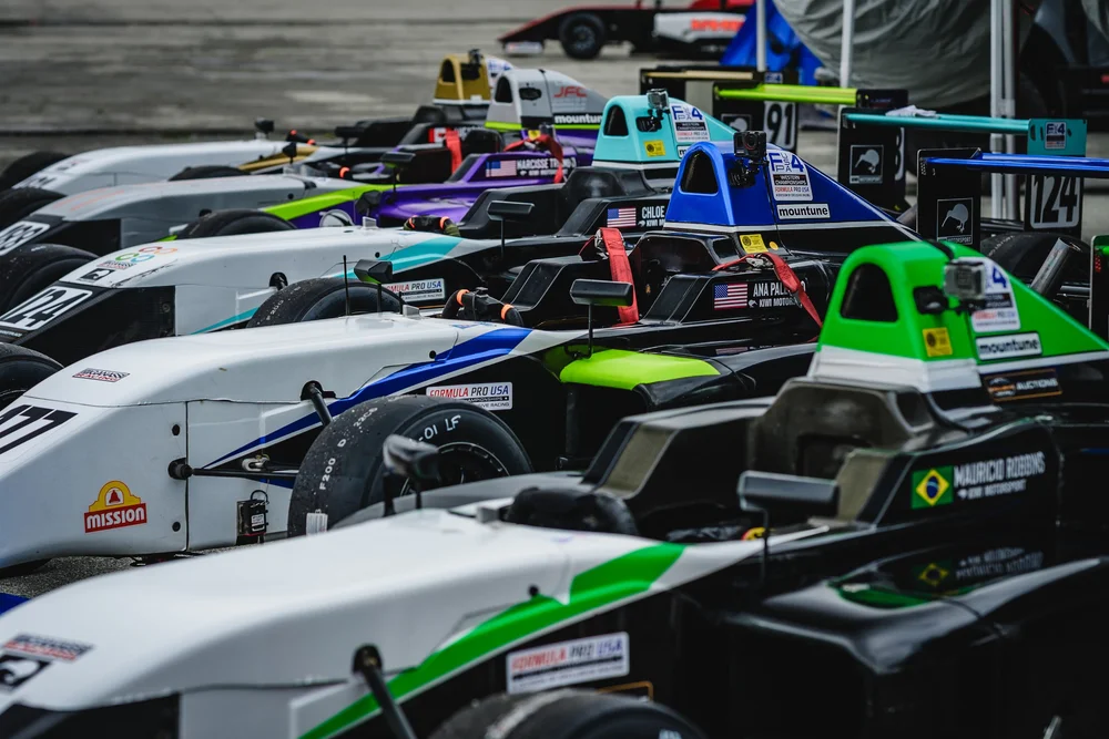 Formula 4 cars lined up in the Laguna Seca paddock during Ana Palestro's Kiwi Motorsport debut weekend, June 2026