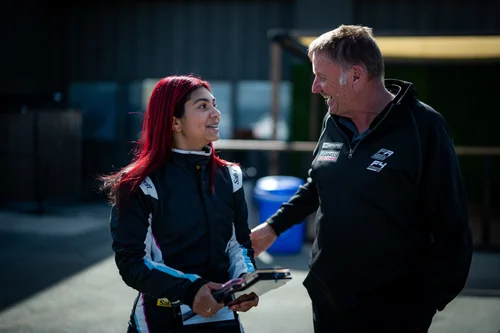 Ana Palestro talking with a Kiwi Motorsport team member at Laguna Seca, June 2026