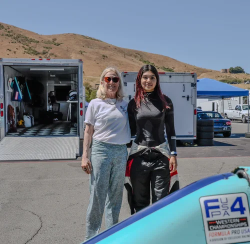 Ana Palestro with a supporter beside her F4 car at Sonoma Raceway during an SCCA event, August 2025