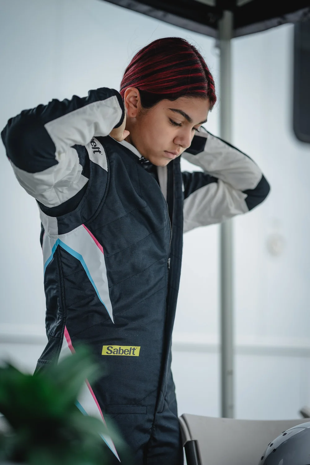 Ana Palestro putting on her racing suit before a session at Laguna Seca