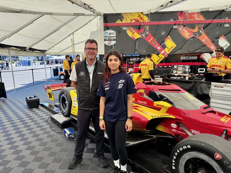 Ana Palestro beside a Chip Ganassi Racing IndyCar at the Grand Prix of Portland, August 2025