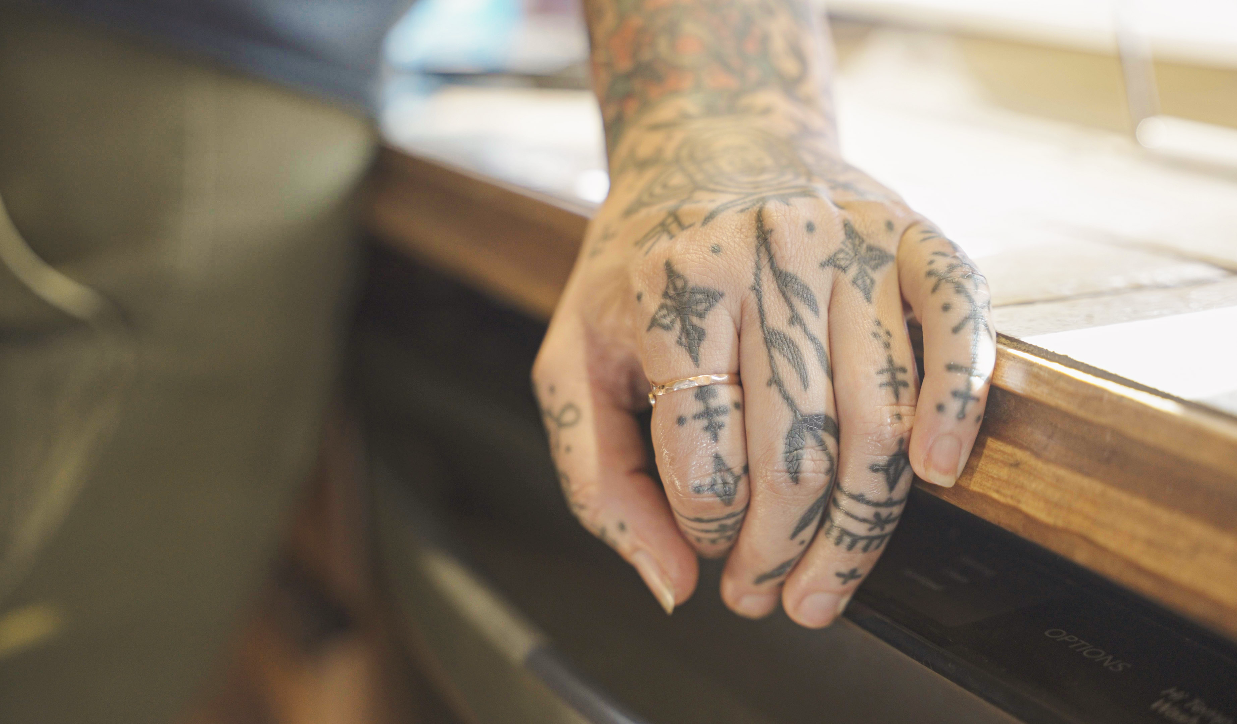 Baylen Levore rests her hand on the counter of her home in the French Broad River Valley, N.C., on May 13, 2025.