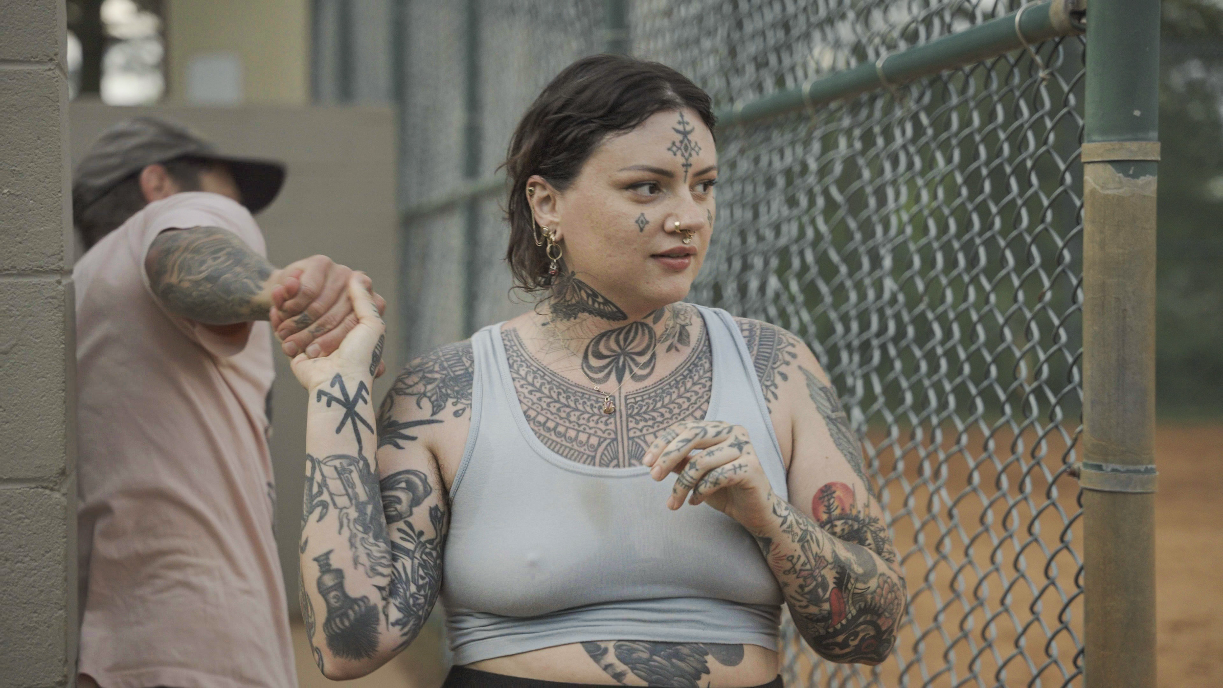 Baylen Levore holds hands with her partner, Shane Donaldson, during a game with Asheville Vortex Baseball at Roger Farmer Park in Asheville, N.C., on May 18, 2025.