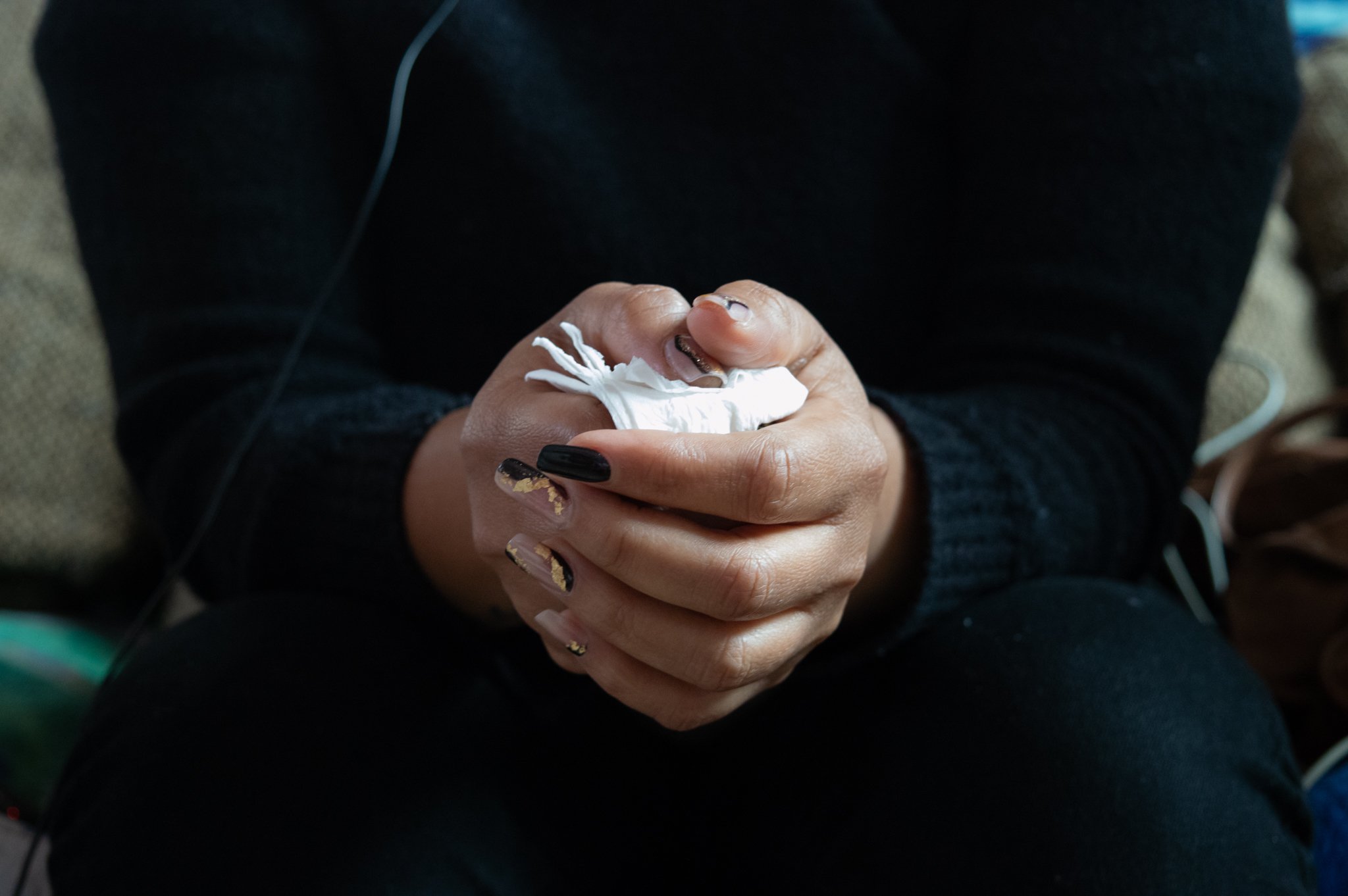 Cler holds a tissue while recounting her experience seeking asylum at the U.S.-Mexico border, at a shelter for women and children in Tijuana, Mexico, on March 14, 2025.