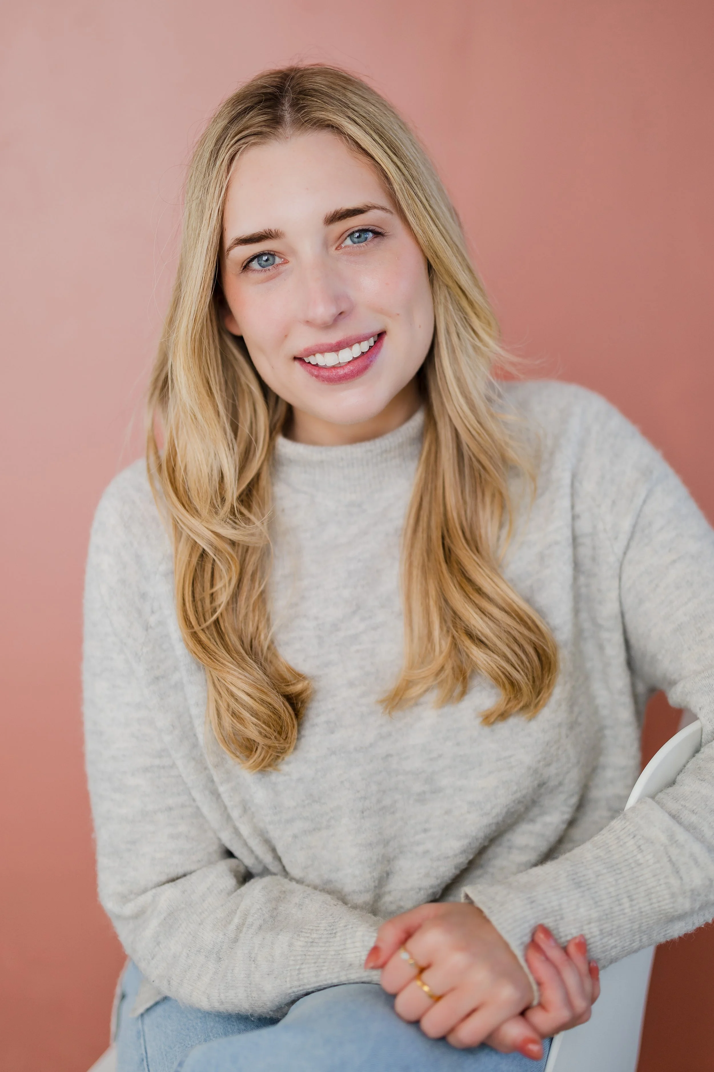 portland Oregon headshot of woman on pink background in studio 
