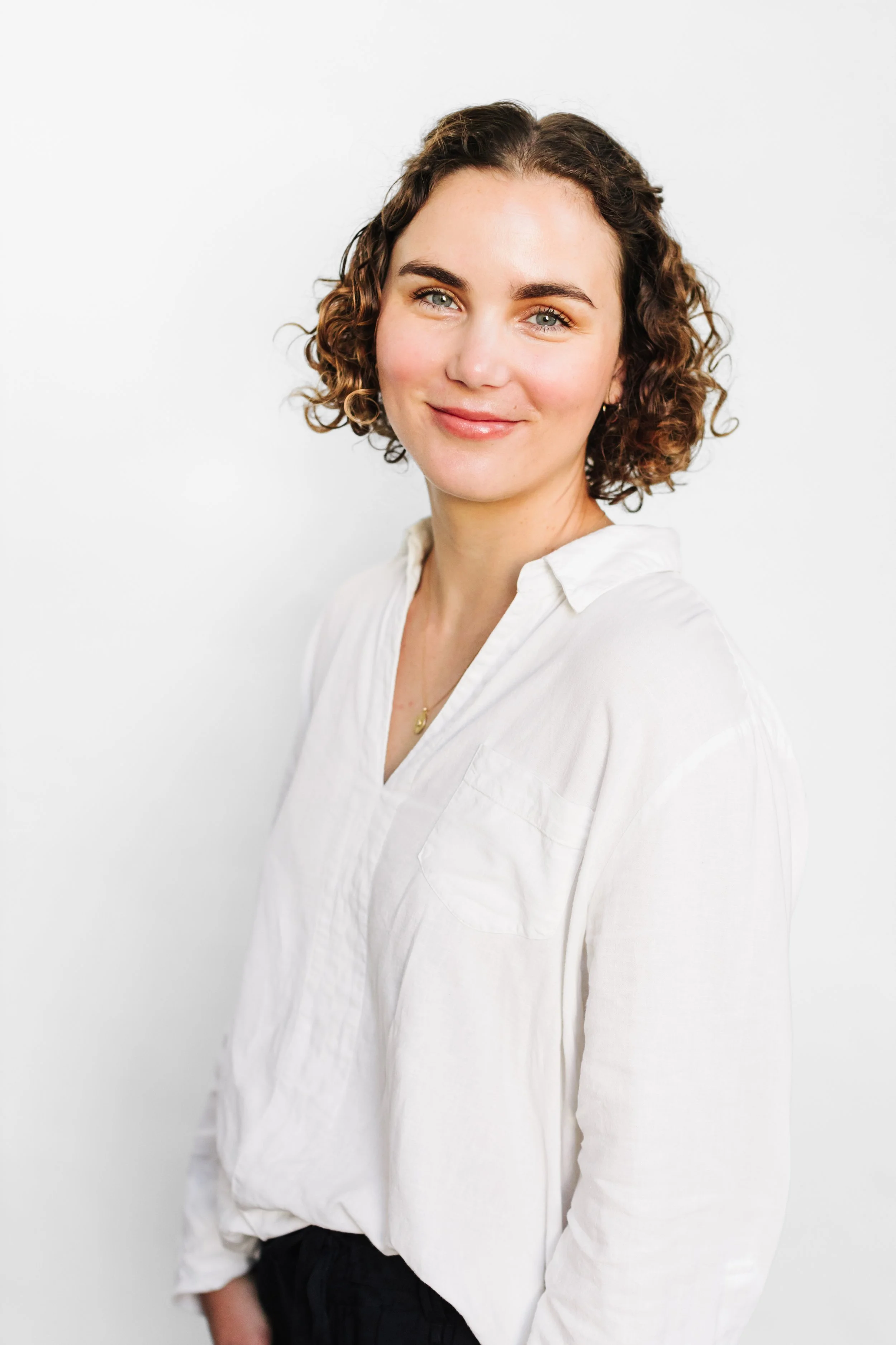 portland Oregon headshot of woman on whit backdrop curly hair