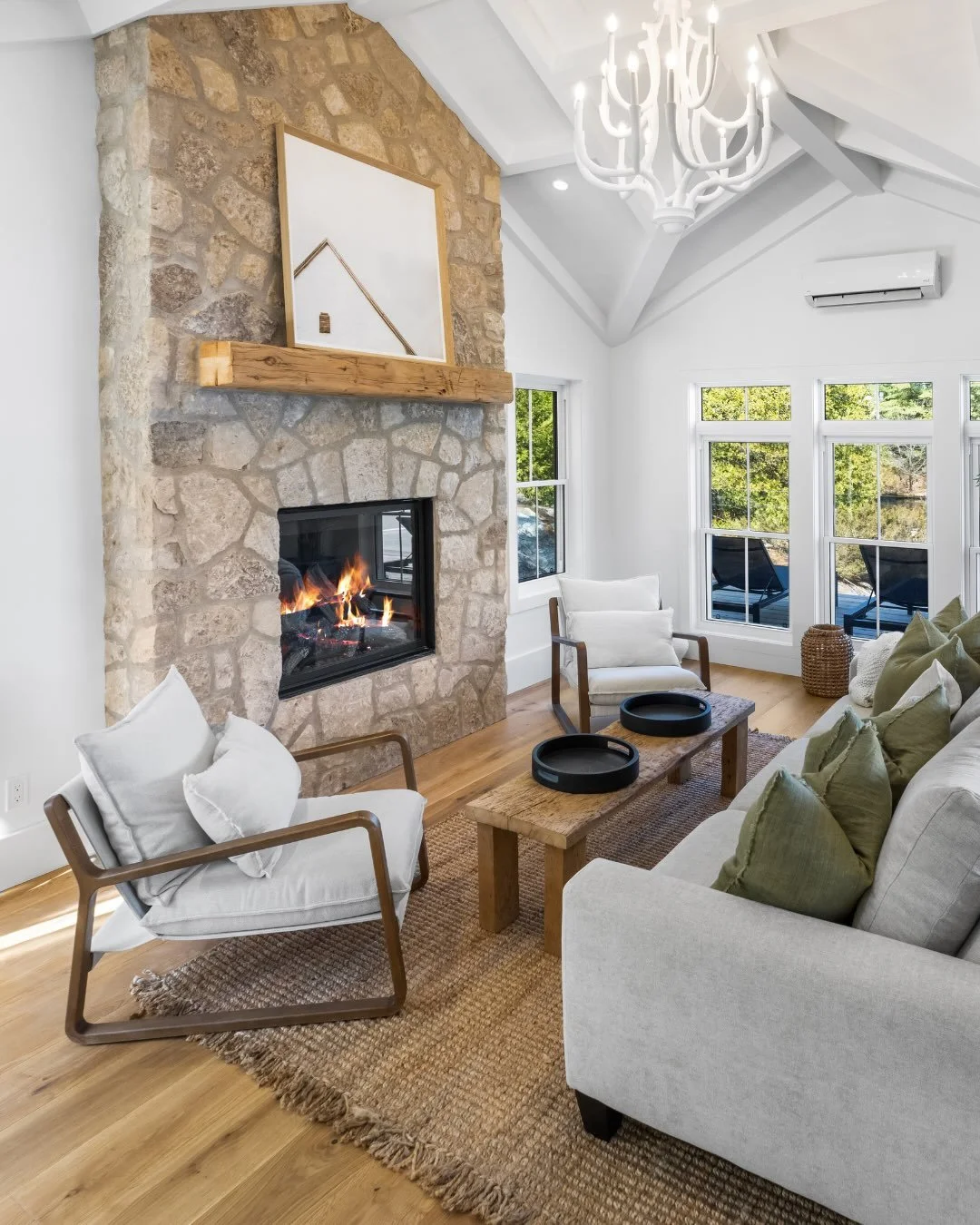 Wake up to panoramic lake views in the living quarters of the Project Narrows boathouse. ⁠
⁠
A walk-out deck extends the bedroom outdoors, while a full-height stone fireplace anchors the space with character and craftsmanship. ⁠
⁠
Contractor: @bredin