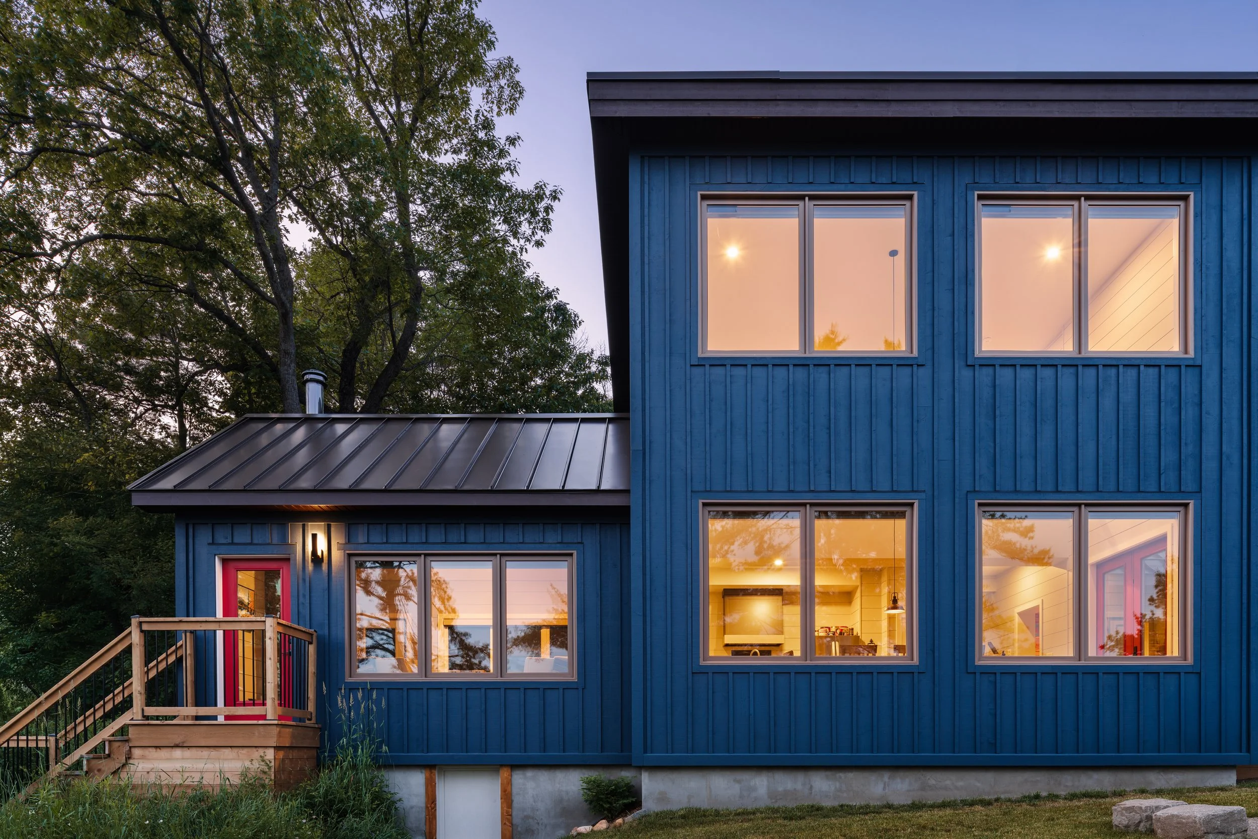Blue board and batten exterior siding of a custom cottage on Lake Muskoka.