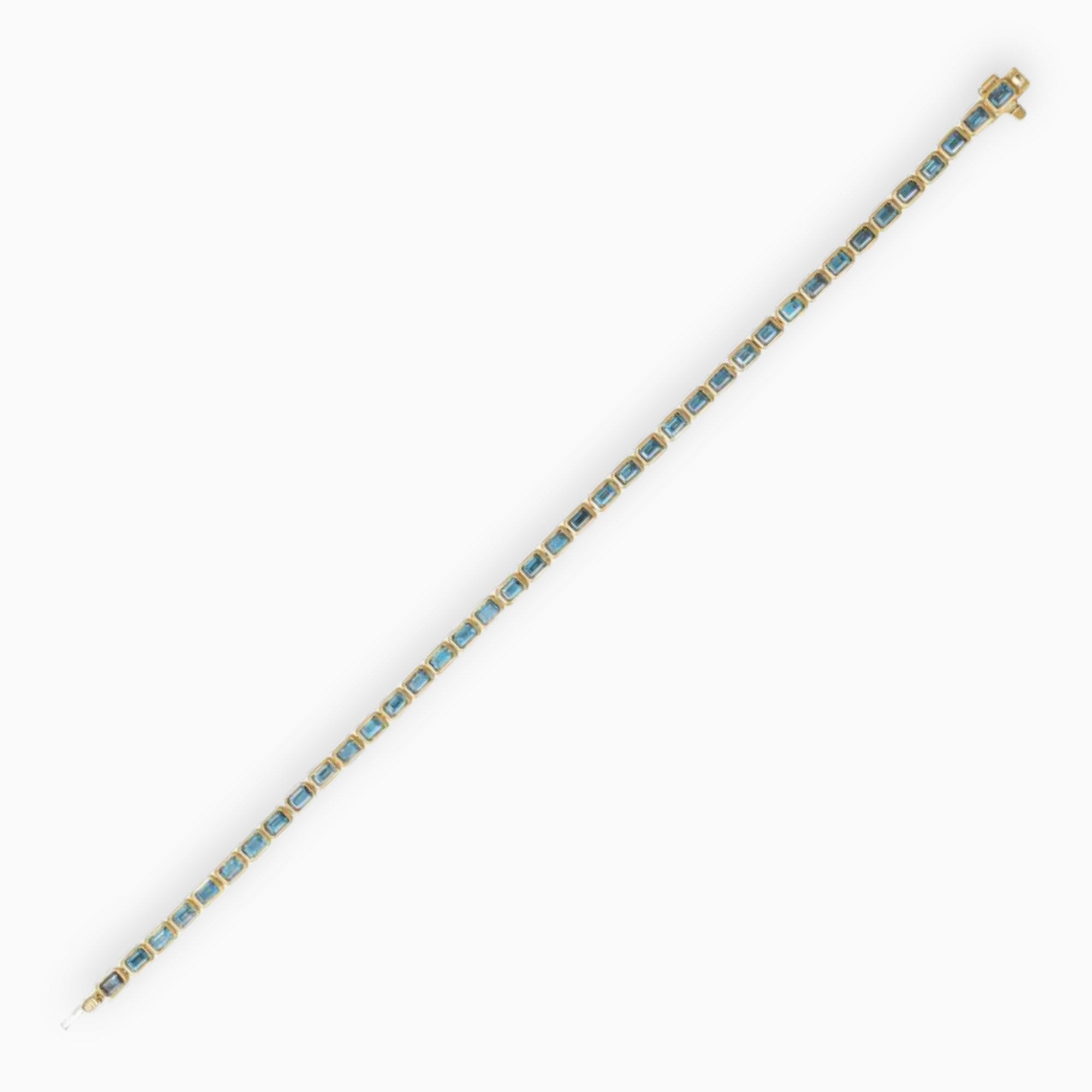 Full length sky blue topaz tennis bracelet in 14K yellow gold with emerald cut stones in bezel settings