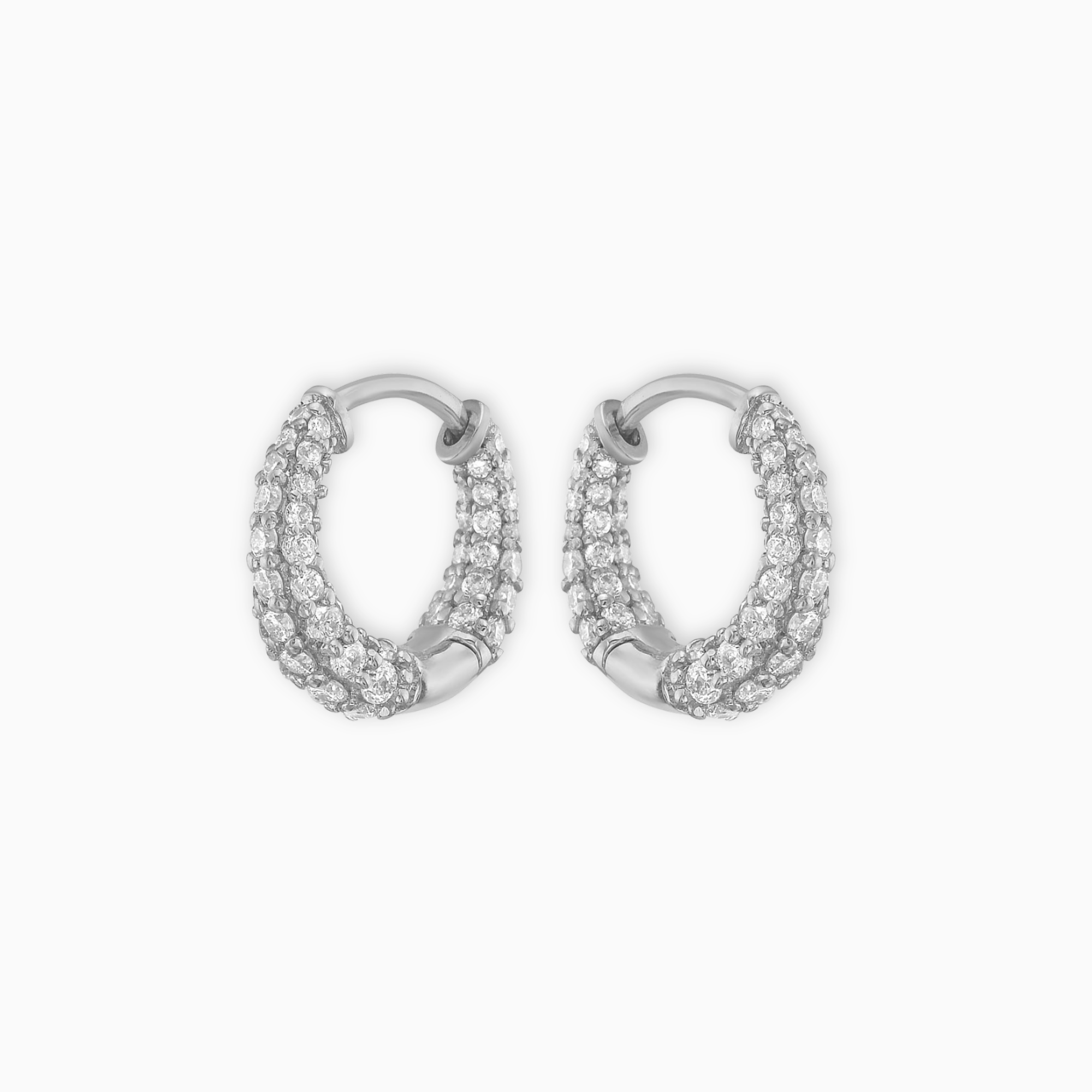 Pair of 14K white gold graduated huggie earrings set with natural round diamonds.png