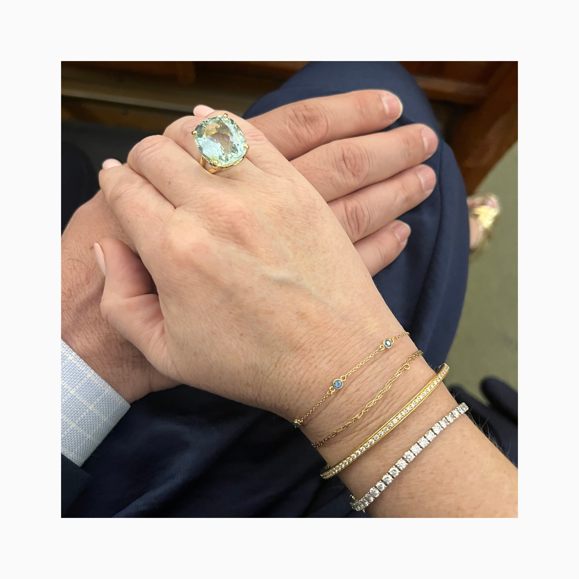 14K yellow gold three-stone aquamarine bracelet layered with Mary James diamond bracelets and the Mary Louise aquamarine ring