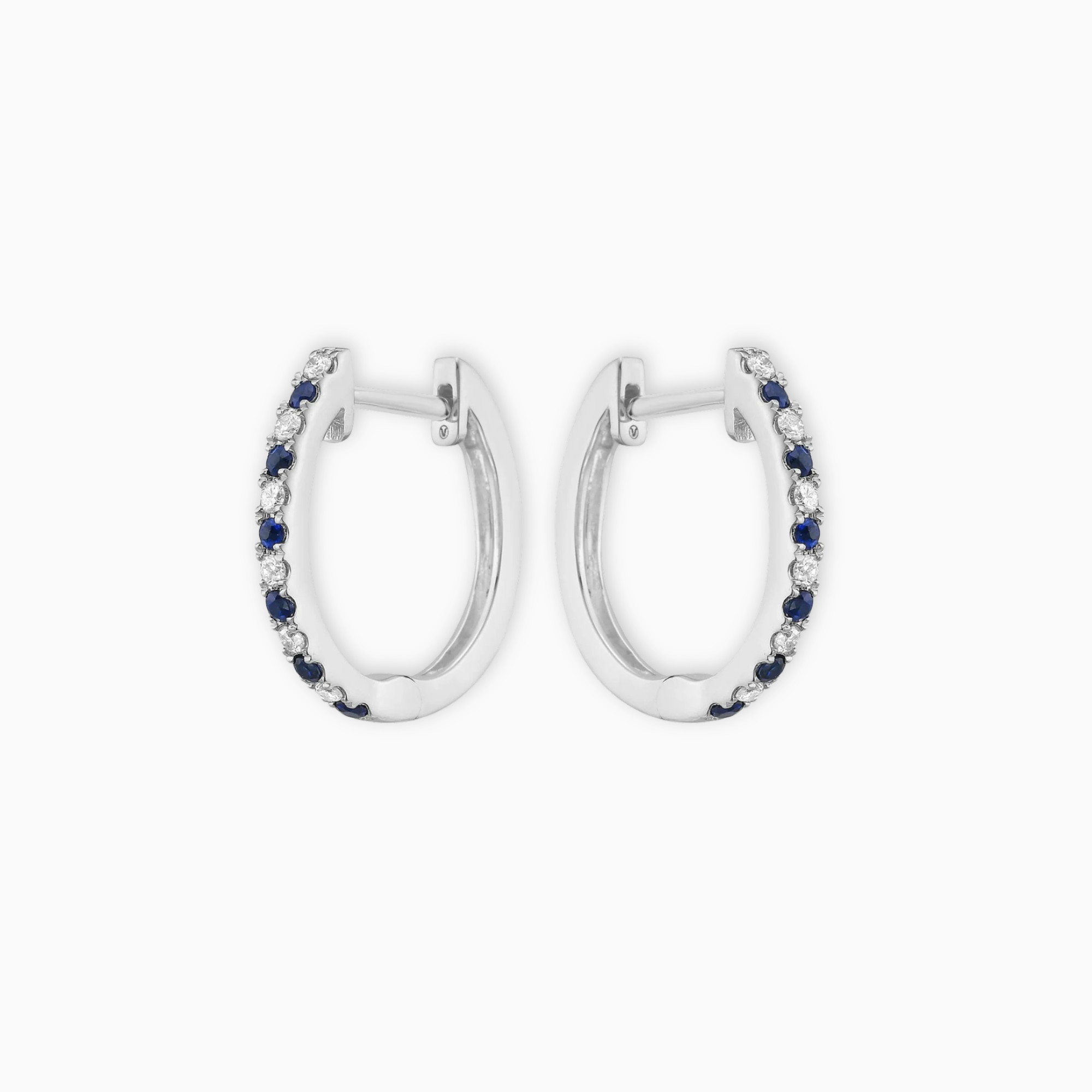 Pair of 14K white gold huggie earrings with alternating blue sapphires and natural diamonds