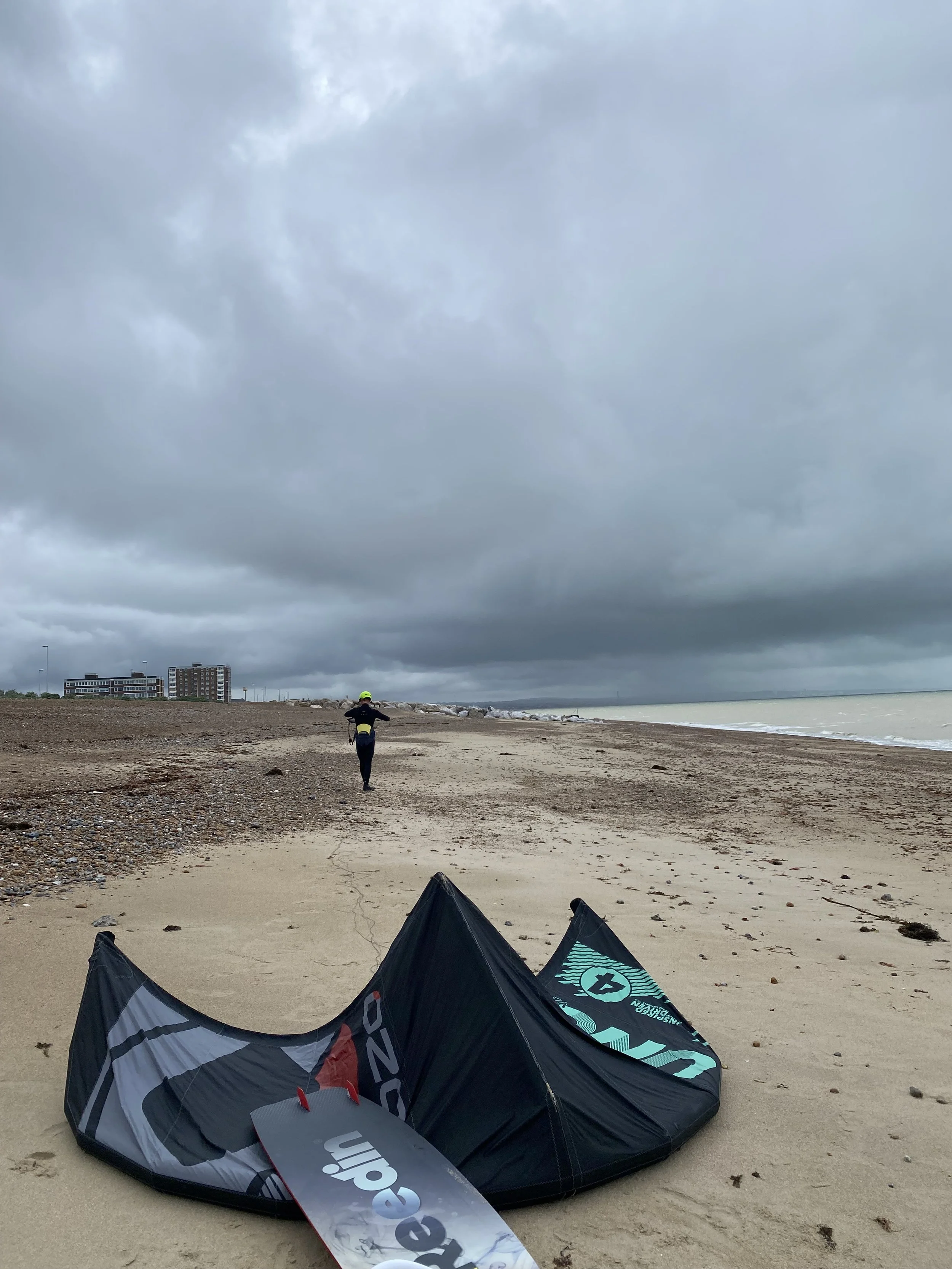 Student setting up kitesurfing equipment on Lancing beach, West Sussex