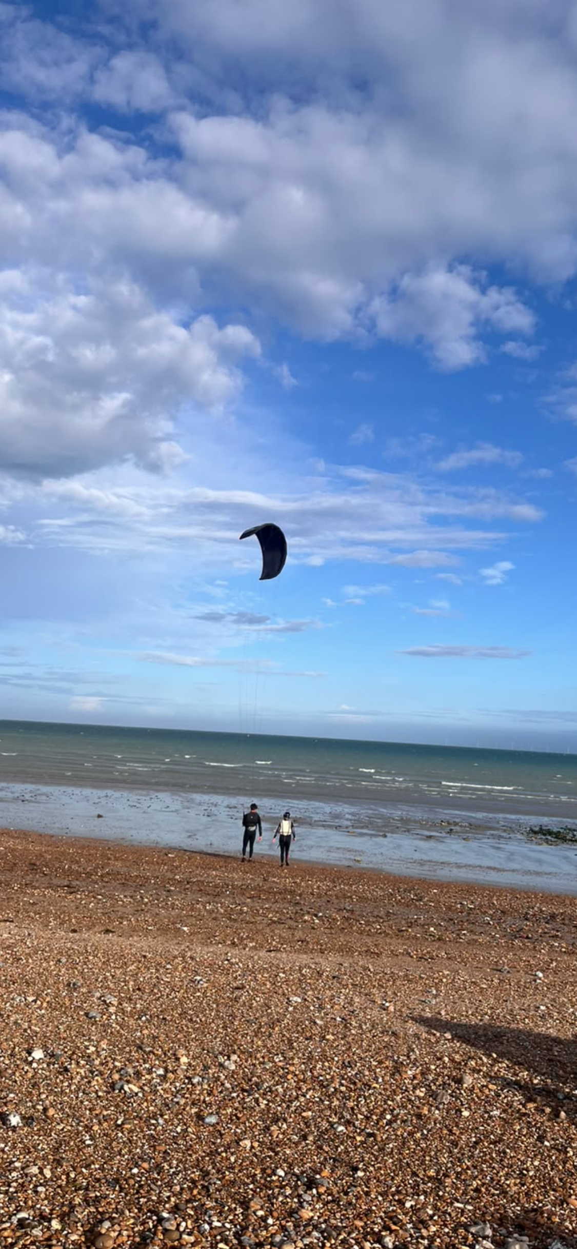 Kitesurfing student learning good kite control techniques from instructor