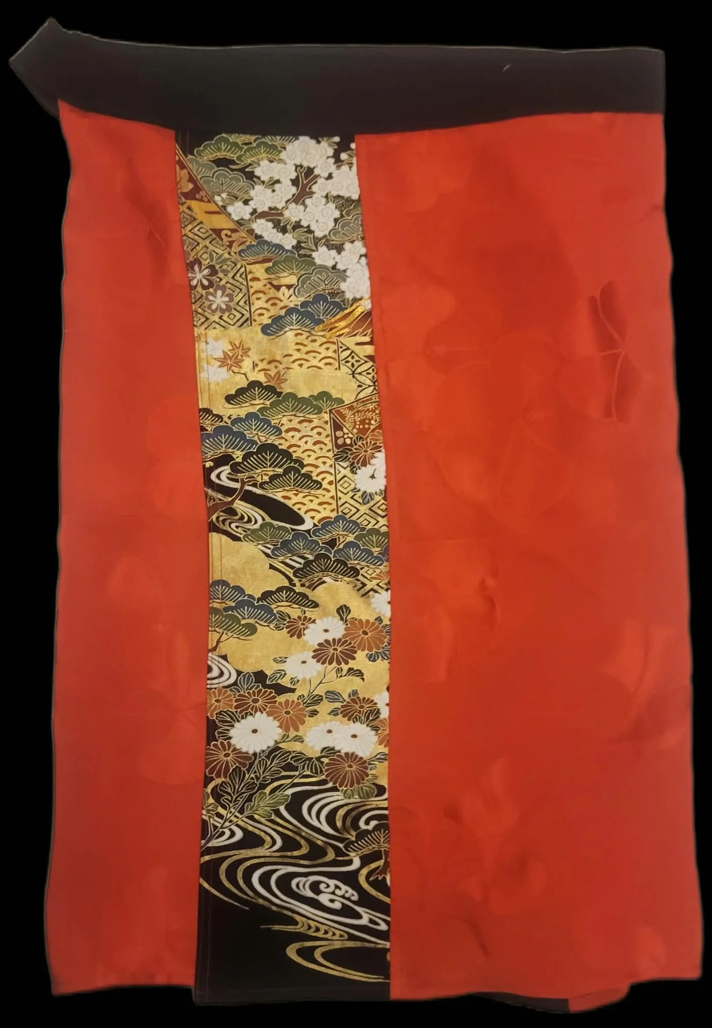 Crimson Current vintage Japanese textile wrap skirt featuring a red tonal floral body, a decorative gold and black patterned front panel, and coordinating fabric ties.