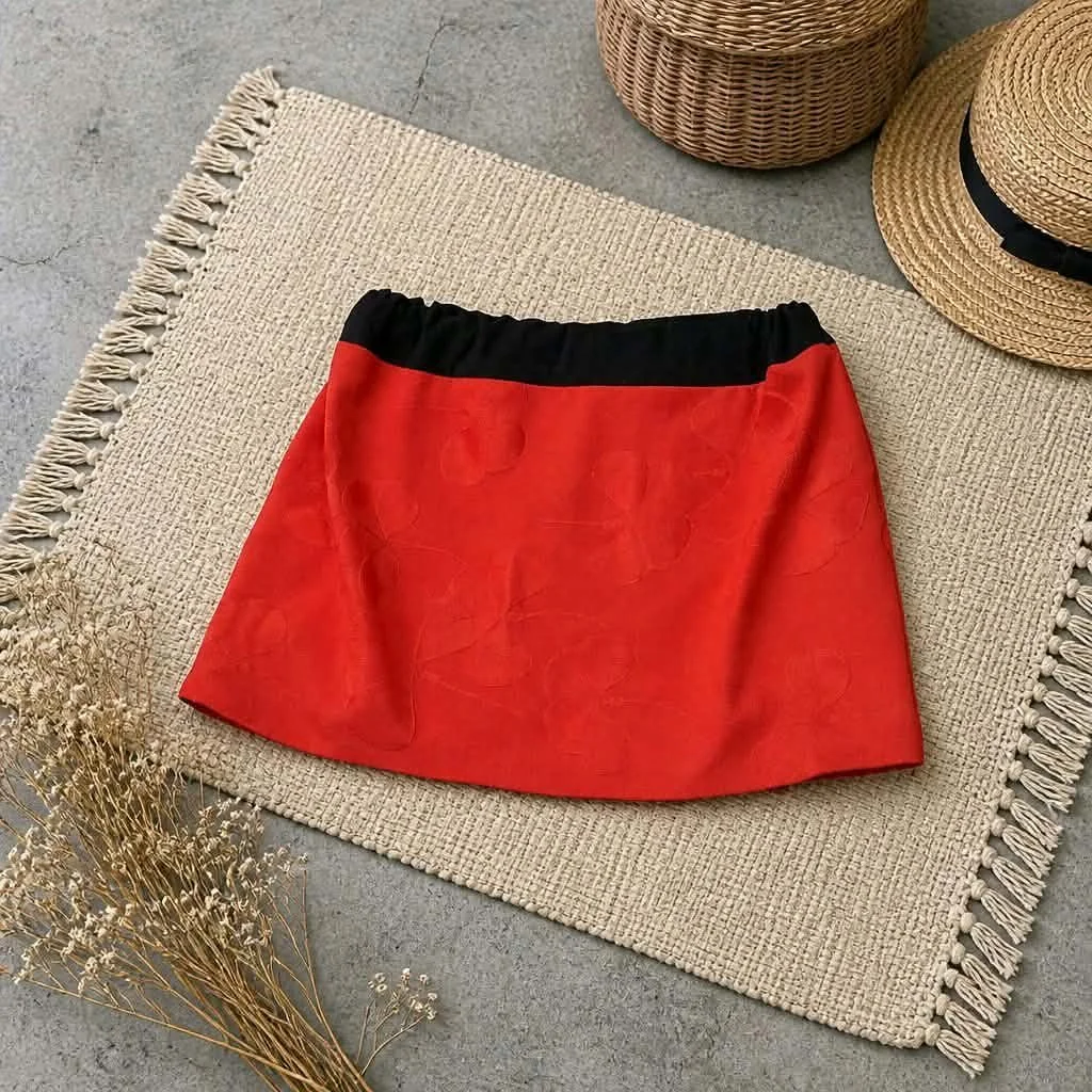 Crimson Petal, a red skirt made from vintage Japanese haori fabric with subtle tonal floral motifs and a contrasting black waistband.