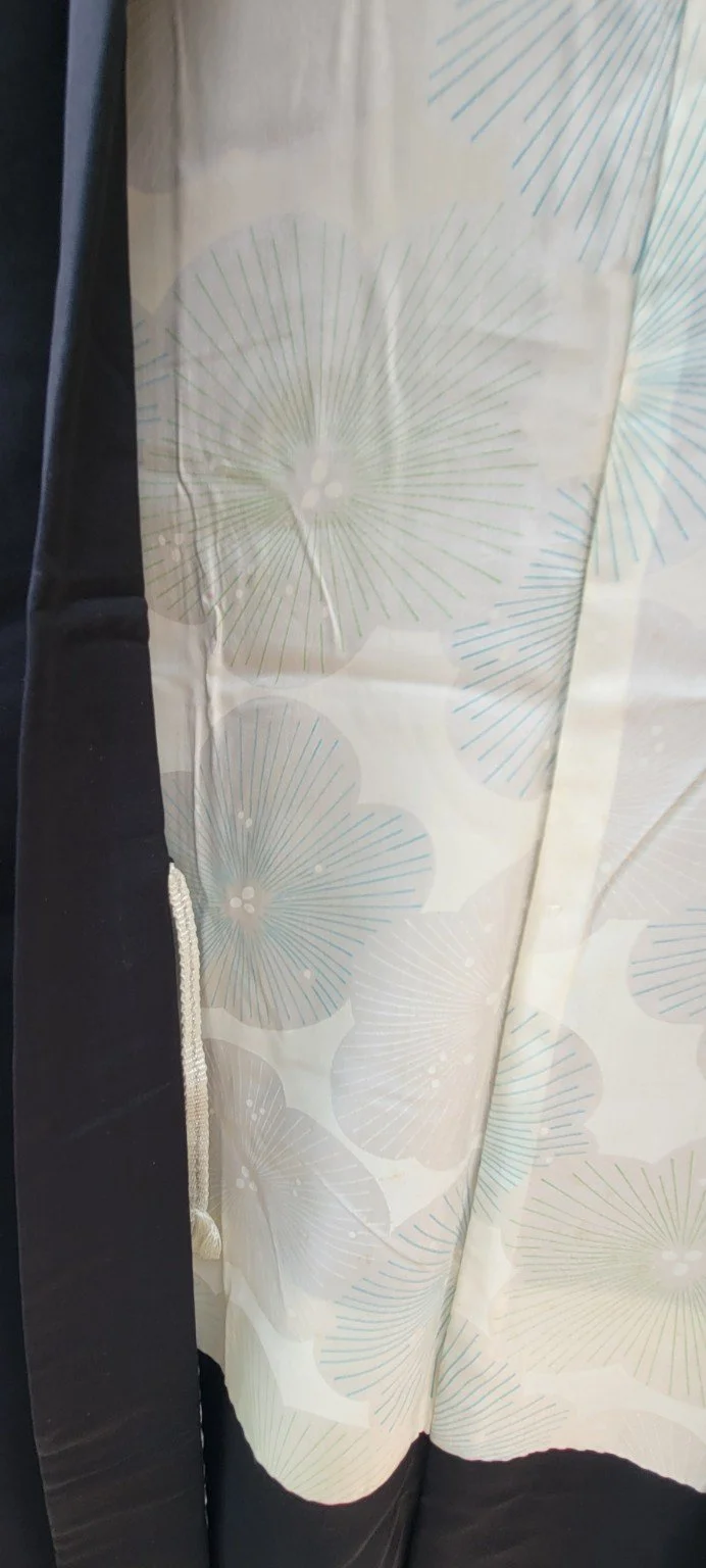 Pale silk lining with blue green and grey radiating circular motifs inside vintage Japanese haori