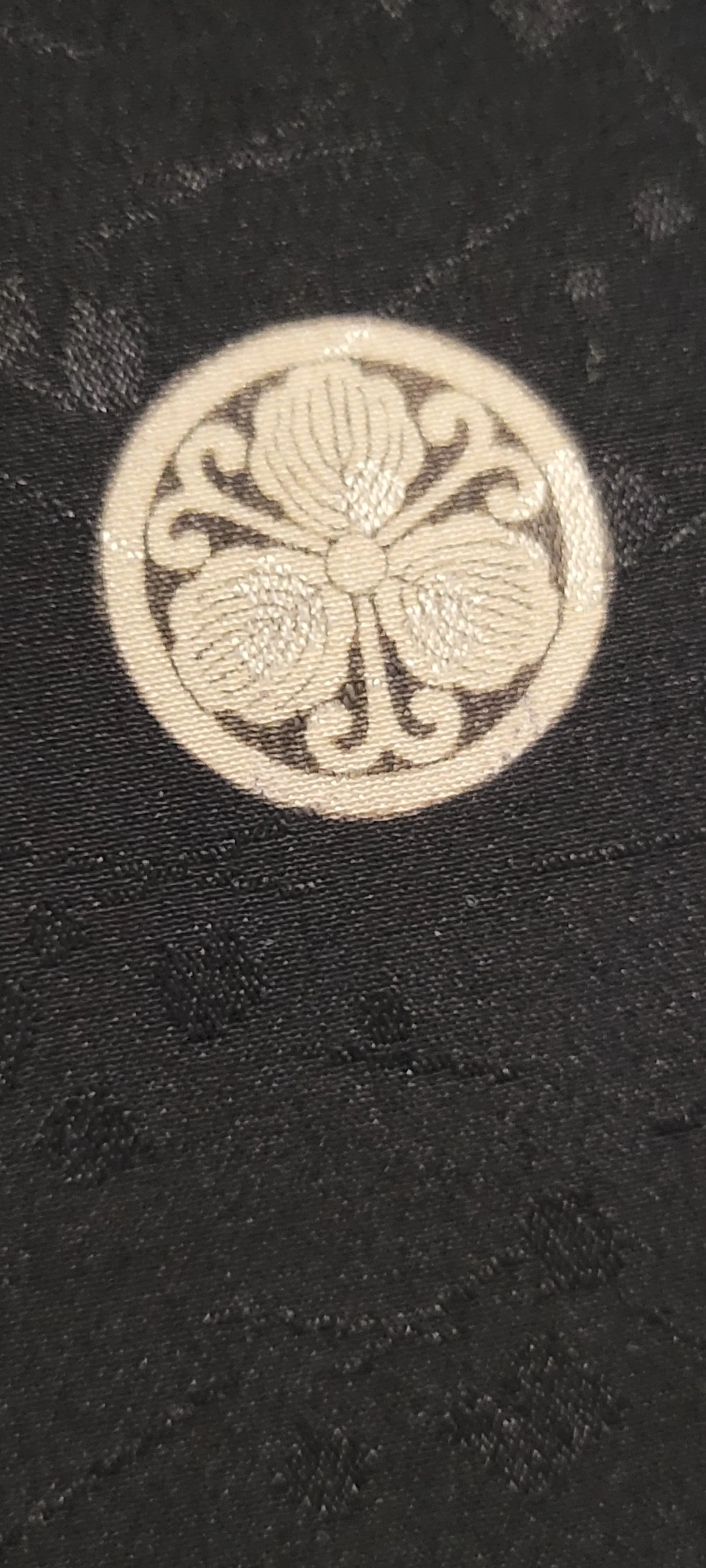 Traditional Japanese kamon family crest on black silk men's haori