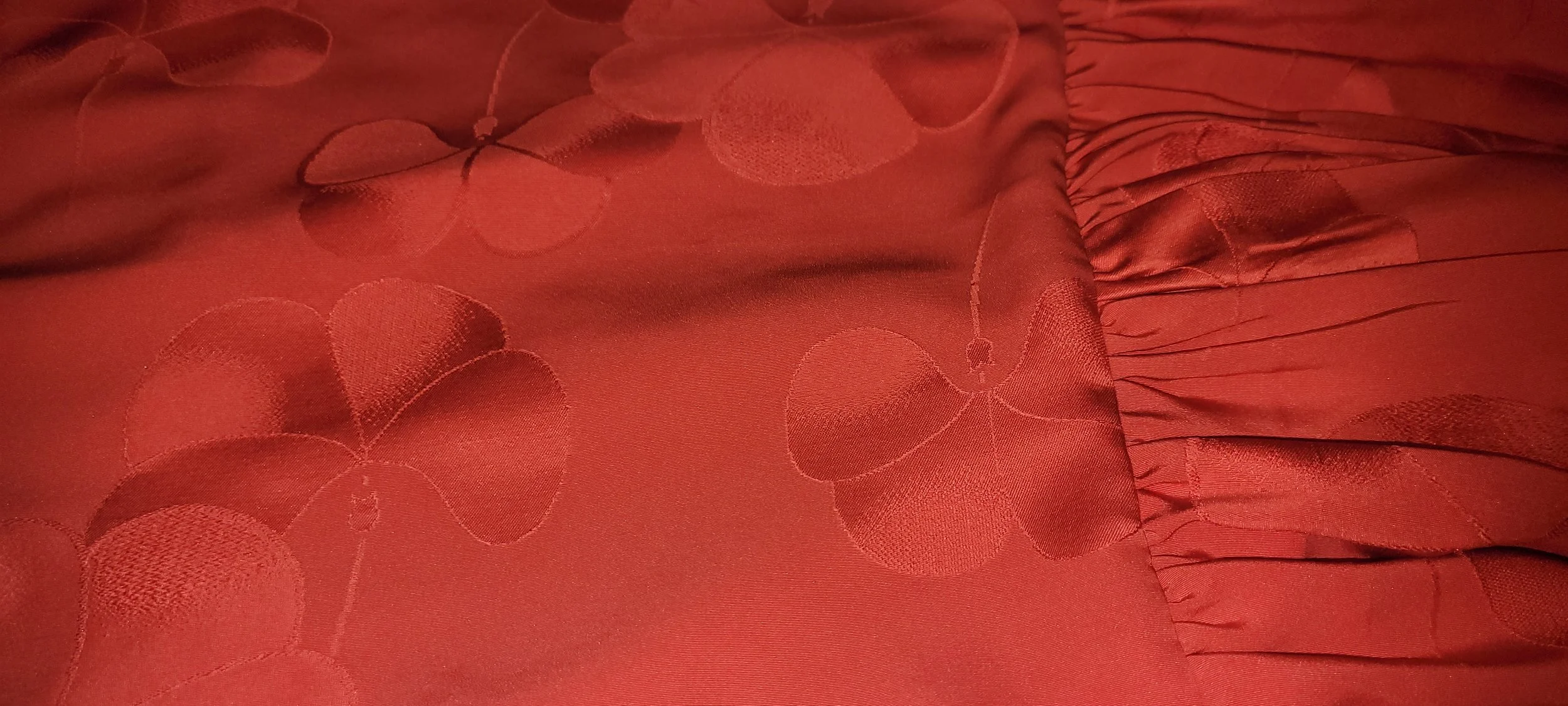 Close-up of the tonal floral pattern and red vintage textile used to create the Crimson Petal skirt.