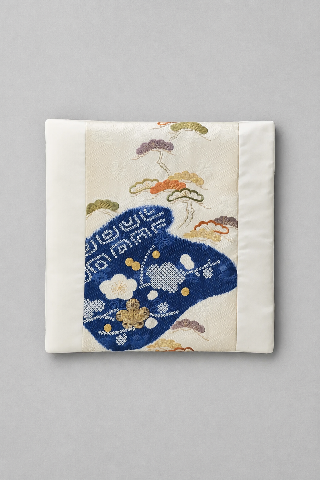 Close-up of Indigo Horizon decorative pillow showing authentic vintage Japanese obi silk with embroidered pine motifs and indigo woven design.