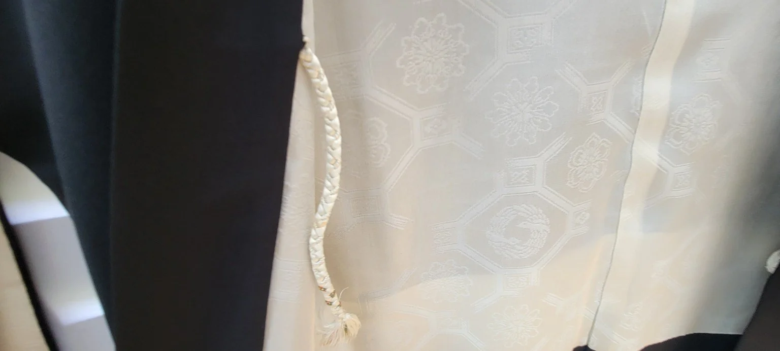 Ivory figured silk lining with geometric floral motifs and braided haori himo
